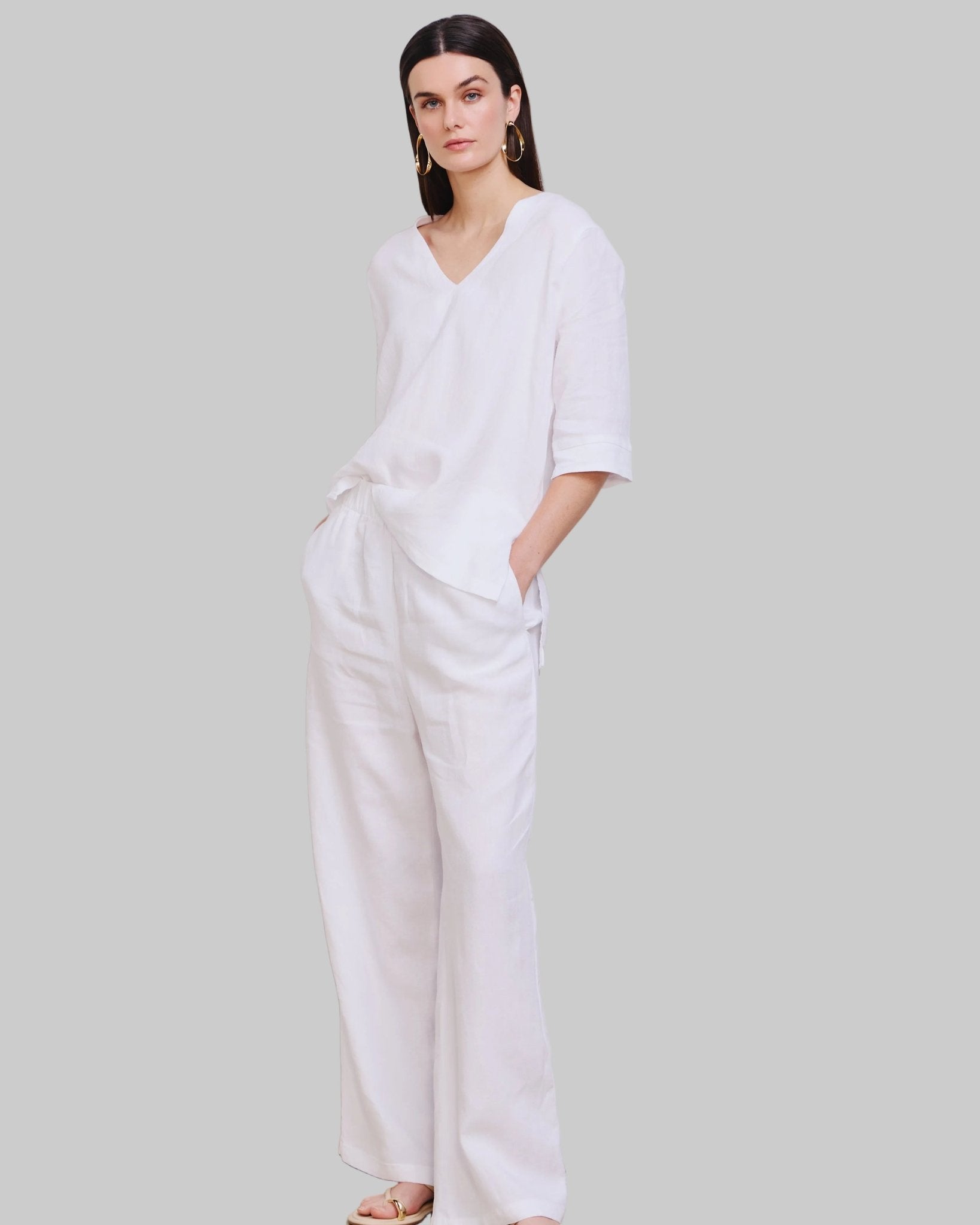 High waist, wide leg white linen pant with pockets and elastic waist band and adjustable hem for joggers with snaps