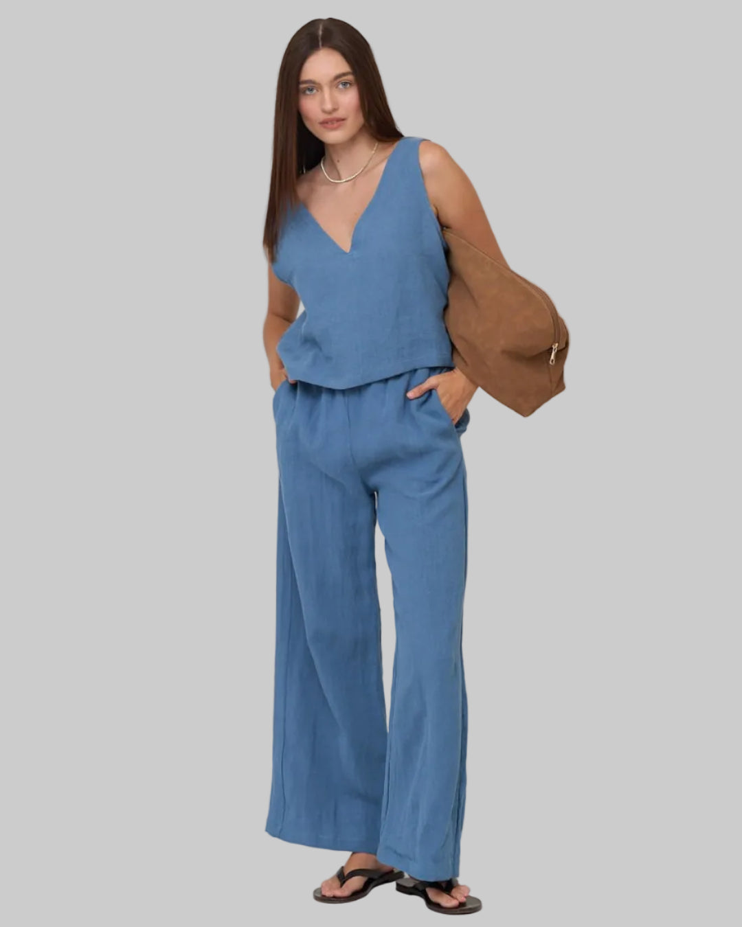 High waist, wide leg light blue linen pant with pockets and elastic waist band and adjustable hem for joggers with snaps