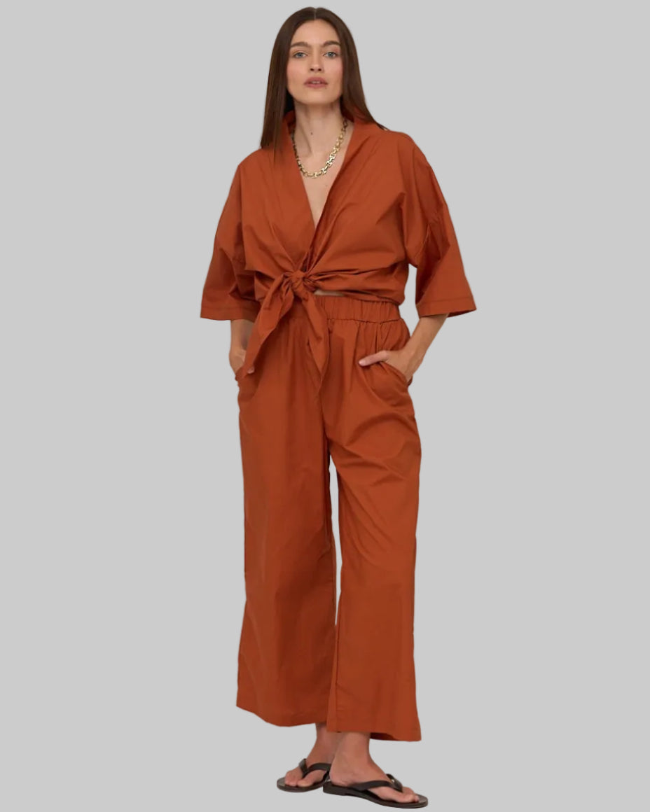 Relaxed, 100% cotton mid to high rise wide leg pant, elastic waist band with pockets. Rust. 