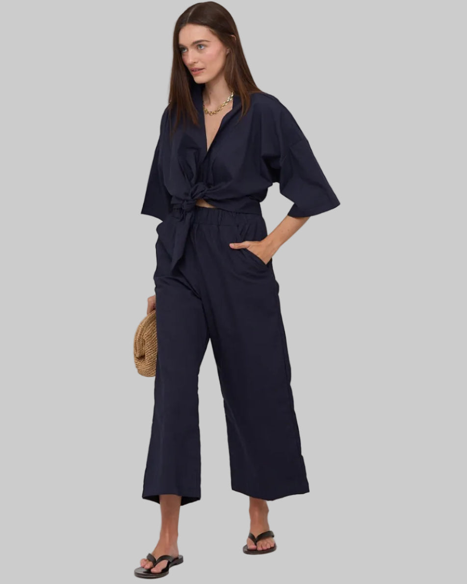 Relaxed, 100% cotton mid to high rise wide leg pant, elastic waist band with pockets. Navy.