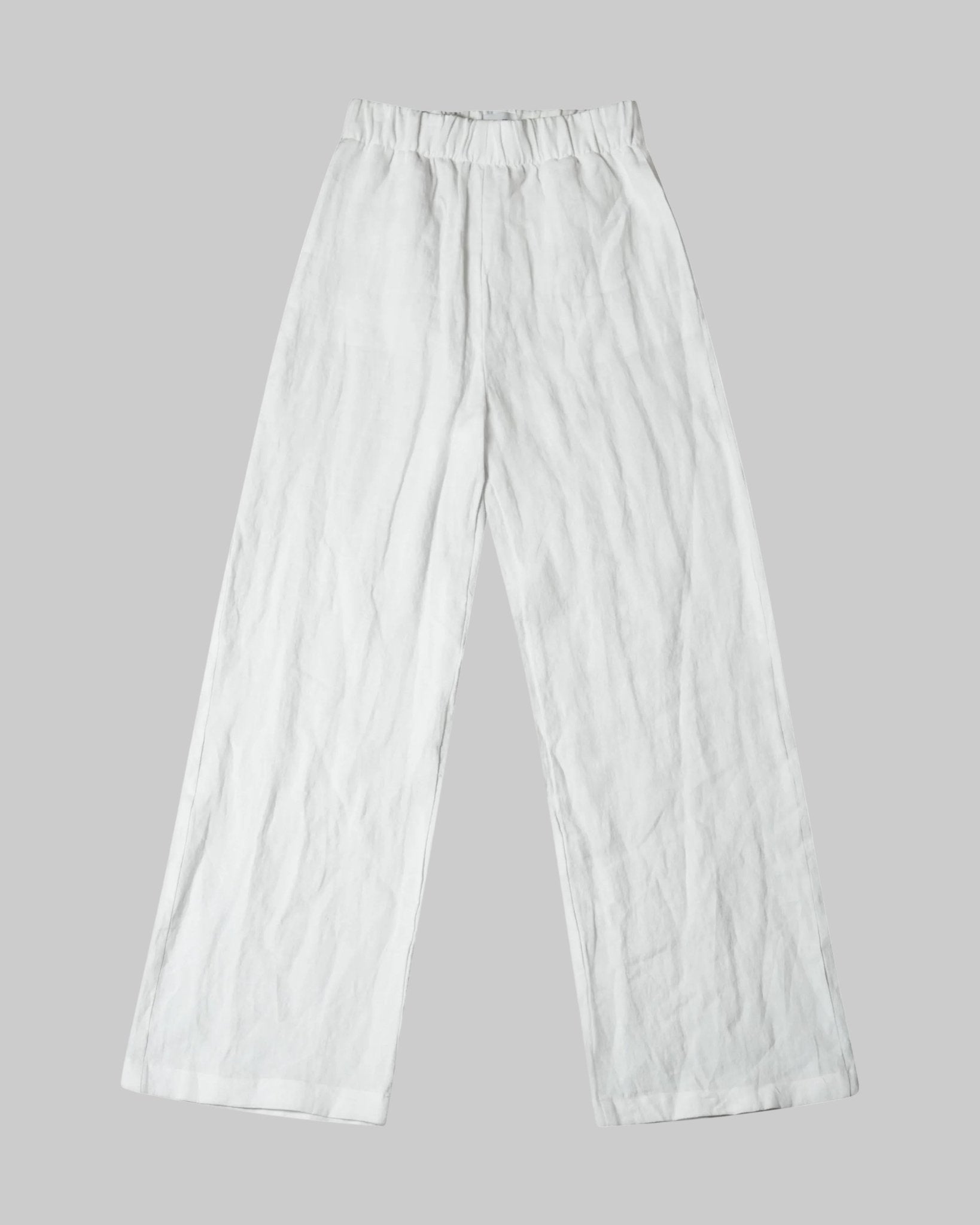 High waist, wide leg white linen pant with pockets and elastic waist band and adjustable hem for joggers with snaps