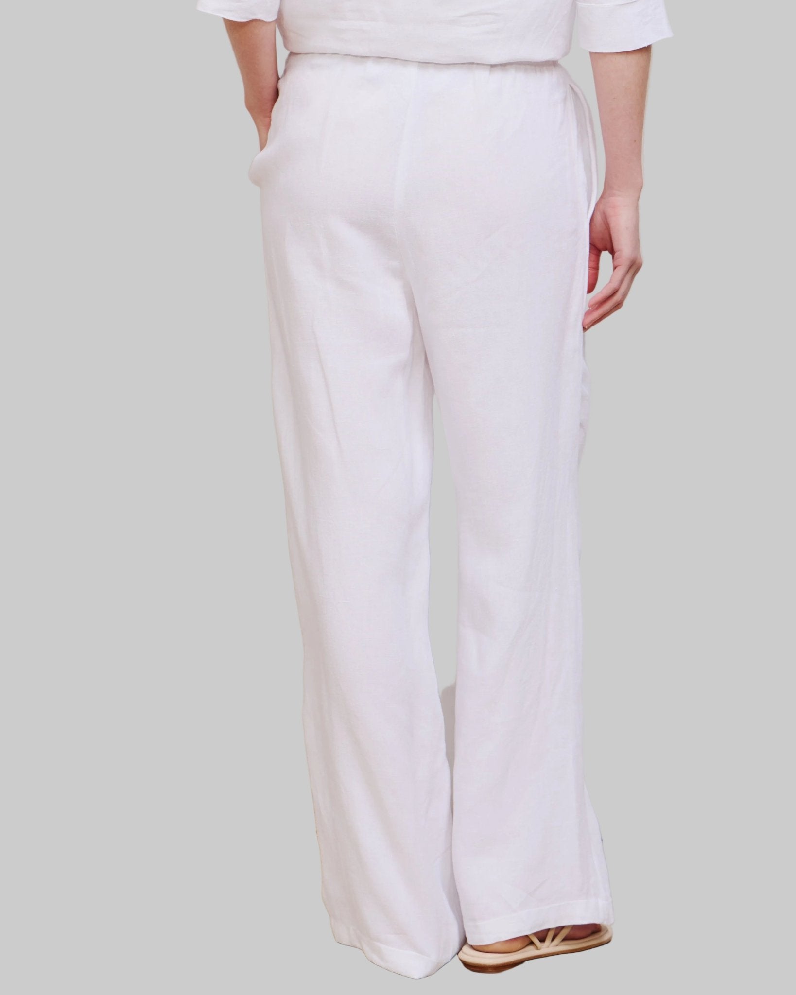 High waist, wide leg white linen pant with pockets and elastic waist band and adjustable hem for joggers with snaps