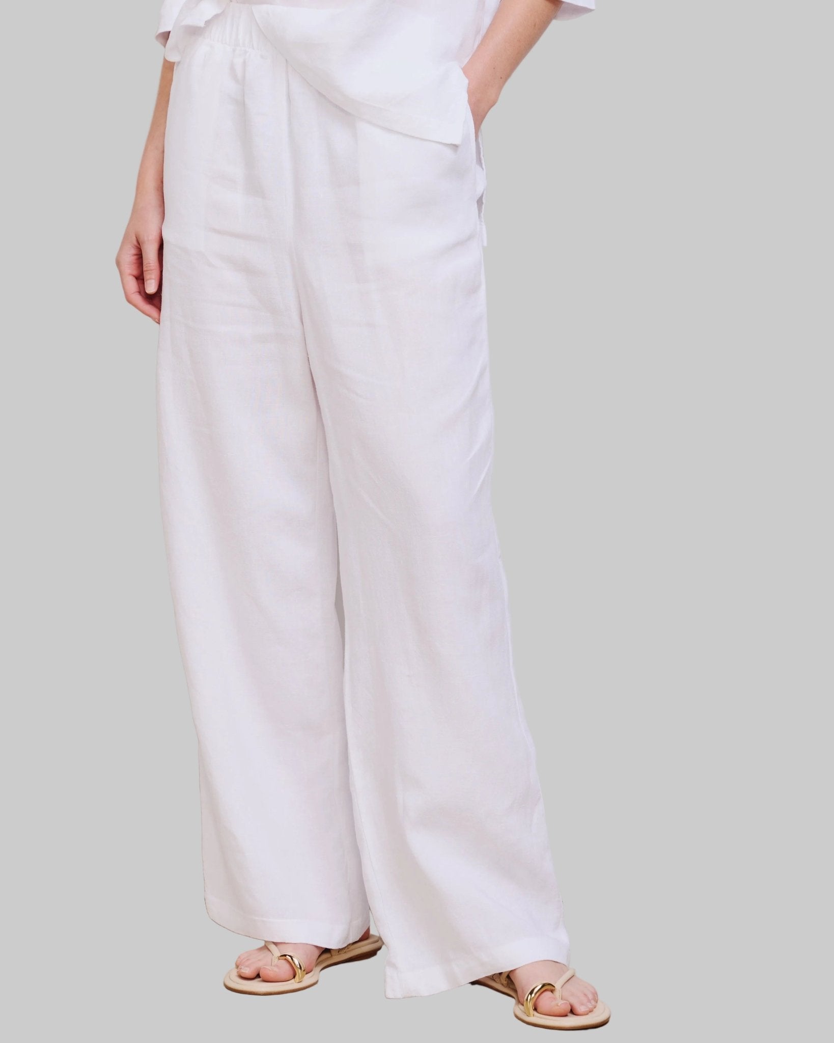 High waist, wide leg white linen pant with pockets and elastic waist band and adjustable hem for joggers with snaps