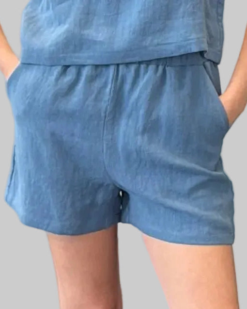 Relaxed fit blue linen short with pockets, elastic waist. Comes with reversible v-neck/boatneck tank (not pictured).
