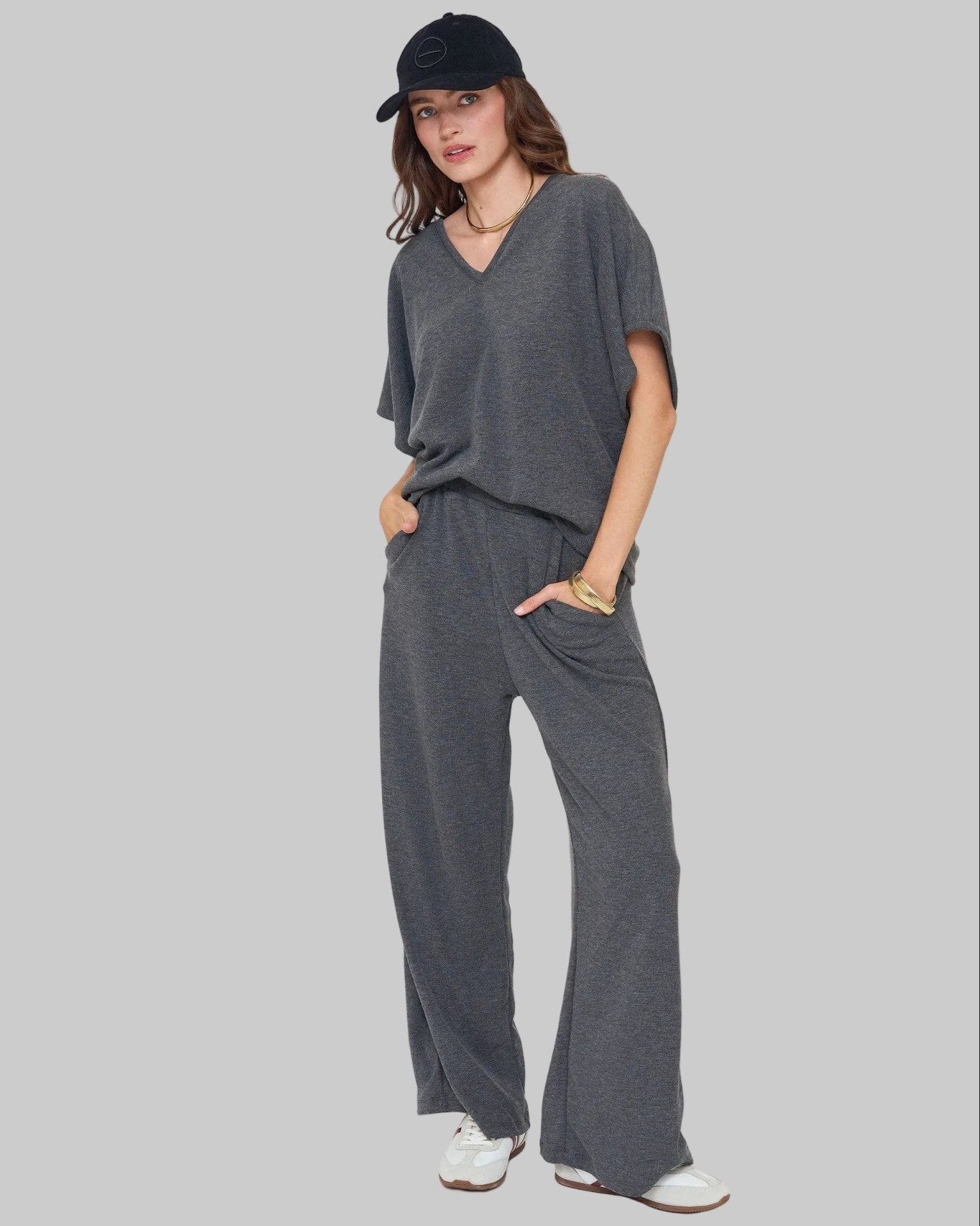 Omni Knit LoLuxurious knit set. Set includes relaxed fit dolman sleeve v-neck top and high waist wide leg lounge pant with pockets. Charcoal. 