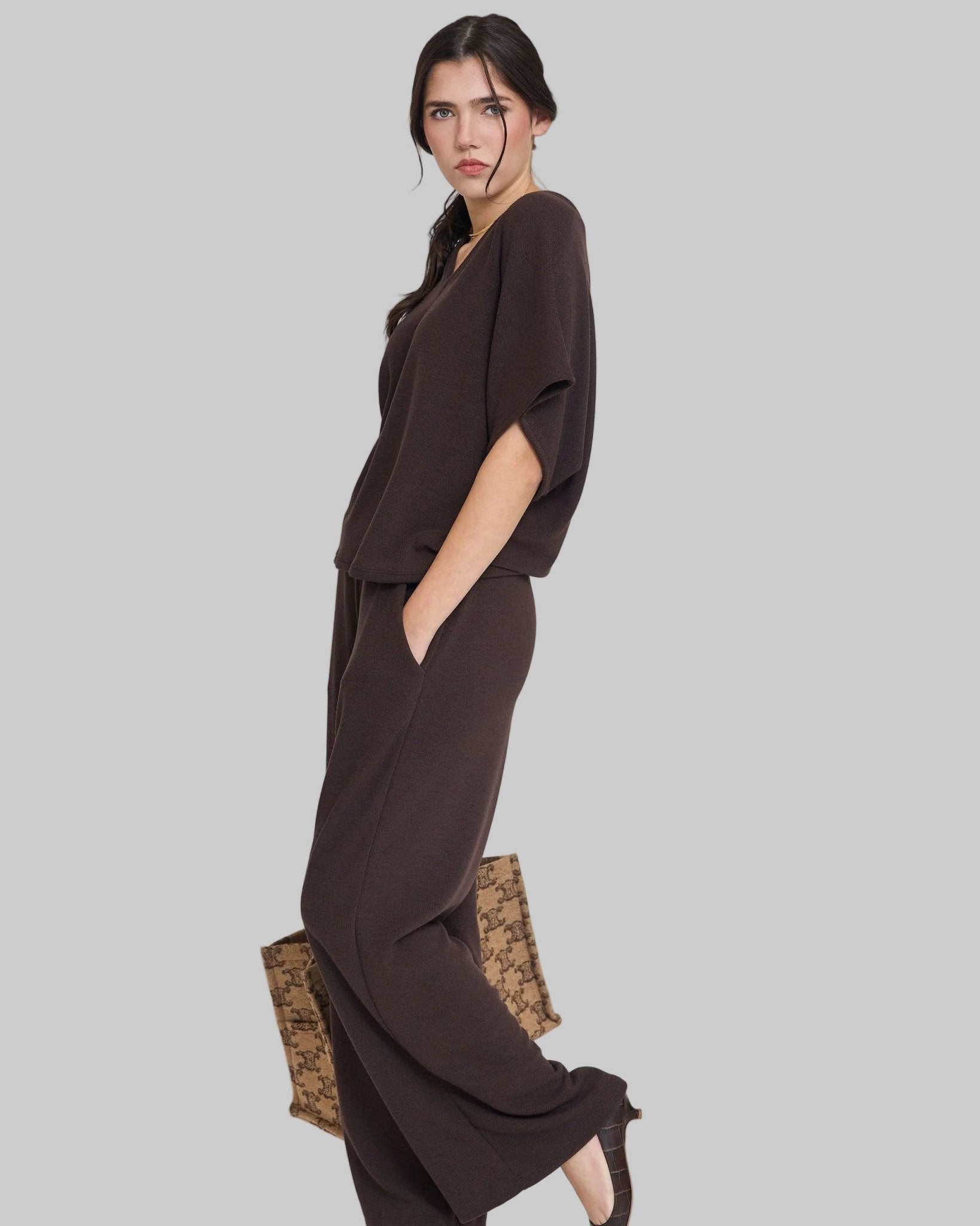Omni Knit LoLuxurious knit set. Set includes relaxed fit dolman sleeve v-neck top and high waist wide leg lounge pant with pockets. 